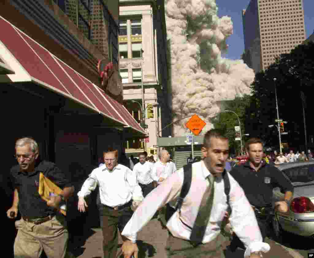 People run from the collapse of World Trade Center Tower in New York.