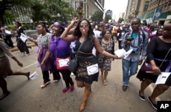 FILE - Kenyan women demand the right to wear whichever clothes they want, at a demonstration in downtown Nairobi, Kenya, Nov. 17, 2014.