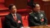 FILE- Xu Caihou, vice chairman of the CPC Central Military Commission, right, and Chongqing party secretary Bo Xilai attend the closing session of the National People's Congress in Beijing's Great Hall of the People in China, March 14, 2012.