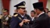 Indonesian President Joko Widodo attaches the rank to the new Armed Forces Chief Marshall Hadi Tjahjanto during an inauguration ceremony at the Presidential Palace in Jakarta, Indonesia, Dec. 8, 2017, in this photo taken by Antara Foto. 
