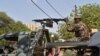 Des soldats patrouillent à bord de leur camion militaire à l'entrée d'un bureau de vote à la mairie de Niamey lors du second tour de l'élection présidentielle, le 20 mars 2016. AFP PHOTO / ISSOUF SANOGO