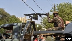 FILE - A soldier patrols on an army truck in Niamey, Niger, March 20, 2016. At least 17 soldiers in Niger were killed in an ambush near the Malian border, a government spokesman said Wednesday.