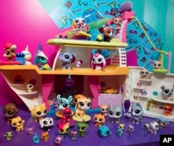 FILE - A demonstrator in the Hasbro showroom during the American International Toy Fair plays with the LITTLEST PET SHOP CRUISE SHIP playset.