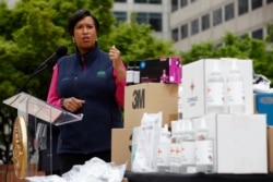 District of Columbia Mayor Muriel Bowser speaks about the District's coronavirus response in front of a table of hand sanitizer and personal protective equipment at a news conference, March 31, 2020, in Washington.