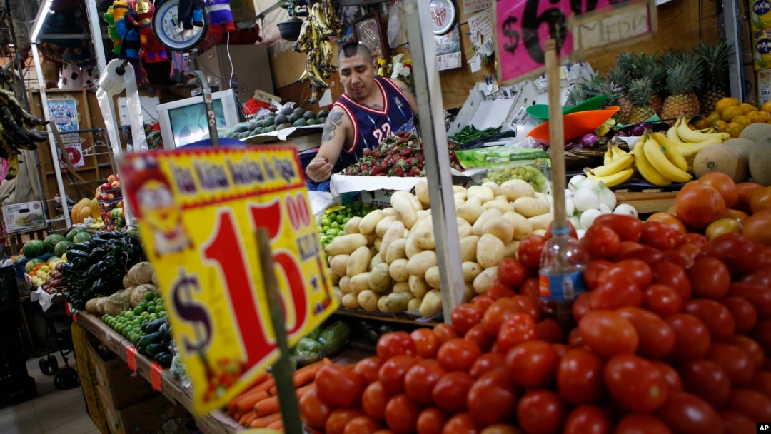 Vendor Luis Alberto Bautista arranges strawberries as he lays out fresh produce at the start of the day in Mercado Medellin, in Mexico City, Feb. 2, 2017. Mexico is the world’s leading exporter of refrigerators and flat-screen TVs, berries, vegetables and other produce. Mexico reached a new free trade agreement with the European Union on Saturday.