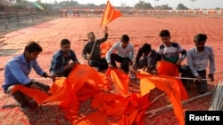  Supporters of the Vishva Hindu Parishad (VHP), a Hindu nationalist organization, prepare flags at the venue of Sunday's "Dharma Sabha" or a religious congregation organized by VHP, in Ayodhya, Uttar Pradesh, India, Nov. 24, 2018.