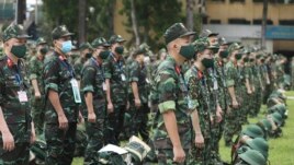 Army soldiers line up during a ceremony to send off military doctors to Ho Chi Minh City to help with treating COVID-19 patients in Hanoi, Vietnam, Monday, Aug. 23, 2021. (Bui Cuong Quyet/VNA via AP)