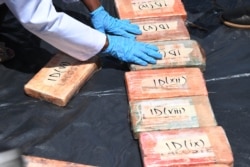 FILE - Kenyan officials display narcotics seized by anti-narcotics detectives in Mombasa in 2016, prior to the destruction at the Directorate of Criminal Investigation in Nairobi, Nov. 6, 2019.