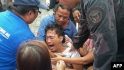 A survivor of a passenger ferry that capsized in rough waters cries after arriving at the pier in Ormoc City, central Philippines, July 2, 2015. 