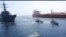 FILE - This frame grab from a video released by Iran's Revolutionary Guard on Nov. 3, 2021, shows Guard boats, center, near a U.S. warship, left, amid the seizure of an oil tanker, right, in the Gulf of Oman. The U.S. Navy said it stopped the seizure of two tankers July 5, 2023.