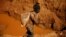 Artisanal gold miners work at an open mine in Mazowe, Zimbabwe, April 5, 2018. 
