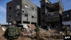 FILE - This picture taken during a media tour organised by the Israeli military on January 8, 2024, shows troops operating in the area of al-Bureij in the central Gaza Strip.