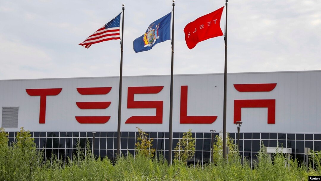 Flags fly over the Tesla Gigafactory 2, which is also known as RiverBend, a joint venture with Panasonic to produce solar panels and roof tiles in Buffalo, New York, Aug. 2, 2018. 