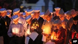 Maine Maritime Academy students bow their heads during a vigil of hope for the missing crew members of the U.S. container ship El Faro, Oct. 6, 2015, in Castine, Maine. 