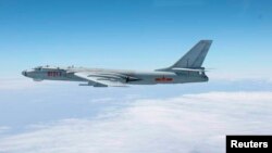 A Chinese military plane H-6 bomber flies through airspace between Okinawa prefecture's main island and the smaller Miyako island in southern Japan in this handout photo taken October 27, 2013 by Japan Air Self-Defense Force.