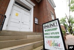 The sign for First Presbyterian Church of Annapolis, Md., displays information for online services, May 22, 2020.