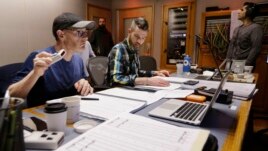 In this Oct. 21, 2019, photo, composer Gordy Haab, left, oversees the recording of his video game soundtrack with the help of Sam Smythe, center, in Nashville, Tenn.