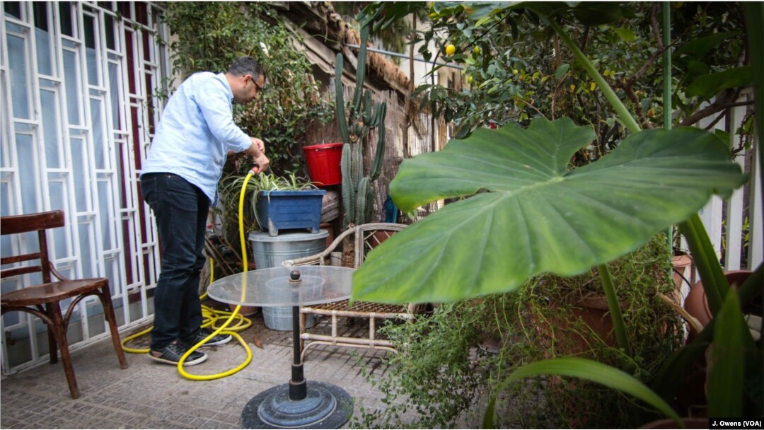Ammar Othman, an architect by trade, enjoying the garden in front of his new home. He grew jasmine back in his garden back in Syria.