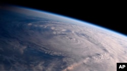 This photo made available by NASA shows Hurricane Harvey over Texas on Aug. 26, 2017, seen from the International Space Station.