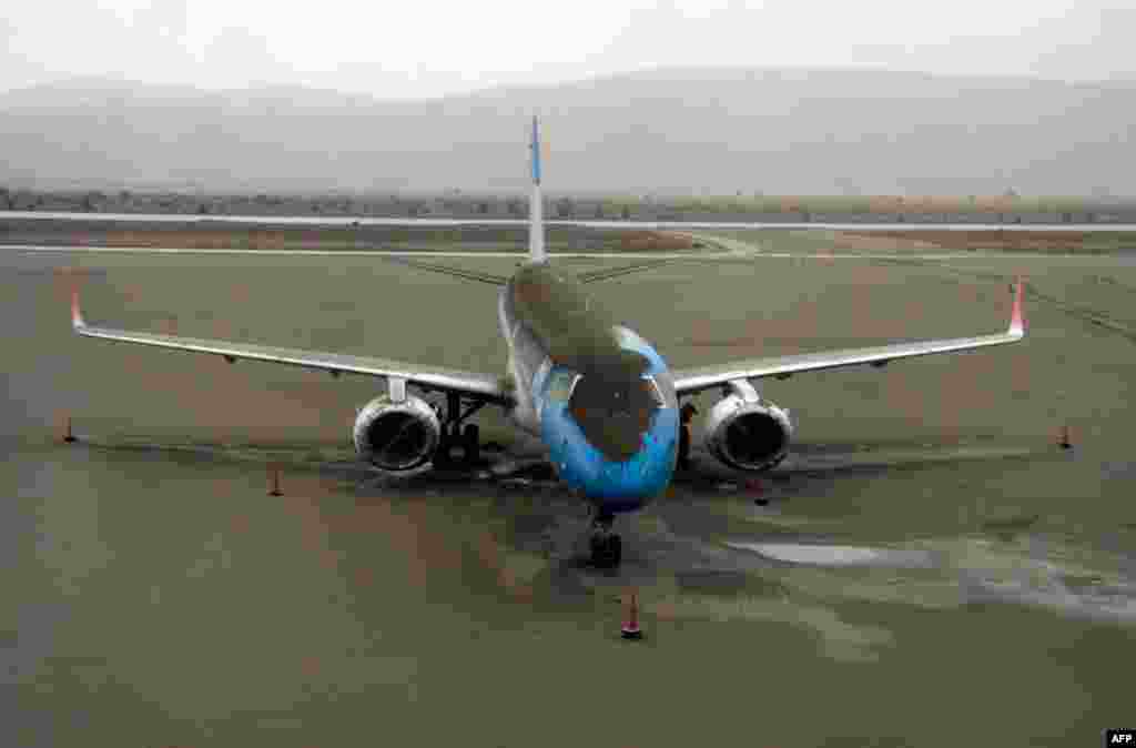 June 7: A plane dusted in volcanic ash sits grounded at the San Carlos de Bariloche airport, Argentina. (AP Photo/Alfredo Leiva)