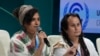 Aya Khourshid, left, speaks next to Jacob Johns as they participate in a panel on Indigenous perspectives at the COP29 U.N. Climate Summit, Monday, Nov. 11, 2024, in Baku, Azerbaijan.