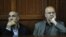 Sayed Mansour Mousavi (L) and Ahmad Abolfathi Mohammed listen to court preceeding before being sentenced to life in prison on terror-related charges, during their trial in Nairobi, May 6, 2013.