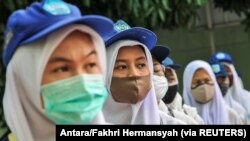 Sejumlah siswa terlihat mengenakan masker pelindung wajah setelah pemerintah Indonesia membuka kembali sekolah di tengah wabah penyakit virus corona di Bekasi, 13 Juli 2020. (Foto: Antara/Fakhri Hermansyah/via Reuters)