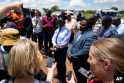 El mayor general Patrick Asaneng, centro, comisionado provincial interino de la provincia del Noroeste, habla con periodistas afuera de una mina de oro abandonada de la cual hubo que rescatar a los mineros, en Stilfontein, Sudáfrica, el 16 de enero de 2025.