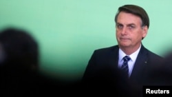 Brazil's President Jair Bolsonaro looks on during a ceremony at the Planalto Palace in Brasilia, Brazil, Nov. 12, 2019. 