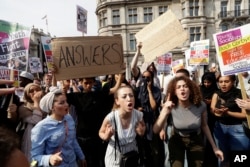 Demonstrators demand justice for the victims of the recent deadly apartment block fire at Grenfell Tower, after marching to parliament in London, June 21, 2017. The mass "Day of Rage" demonstration is timed to coincide with the state opening of parliament.