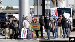 FILE - Supporters of President Donald Trump gather outside Tom Bradley International Terminal as protests against President Trump's executive order banning travel from seven Muslim-majority countries continue at Los Angeles International Airport Sunday, J
