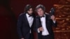 Enrique Costa, left, and Miguel Morales accept on behalf of Jacques Audiard the best European film award for 'Emilia Perez' during the 39th Goya Awards ceremony in Granada, Spain, on Feb. 8, 2025.