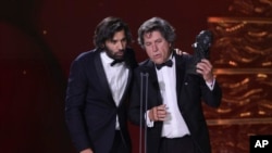 Enrique Costa, left, and Miguel Morales accept on behalf of Jacques Audiard the best European film award for 'Emilia Perez' during the 39th Goya Awards ceremony in Granada, Spain, on Feb. 8, 2025.