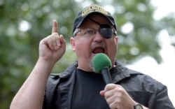 FILE - In this June 25, 2017 file photo, Stewart Rhodes, founder of the citizen militia group known as the Oath Keepers speaks during a rally outside the White House in Washington.
