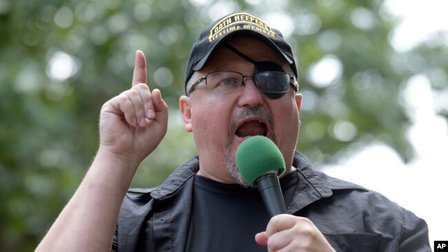 FILE - Stewart Rhodes, founder of the citizen militia group known as the Oath Keepers, speaks during a rally outside the White House in Washington, June 25, 2017.