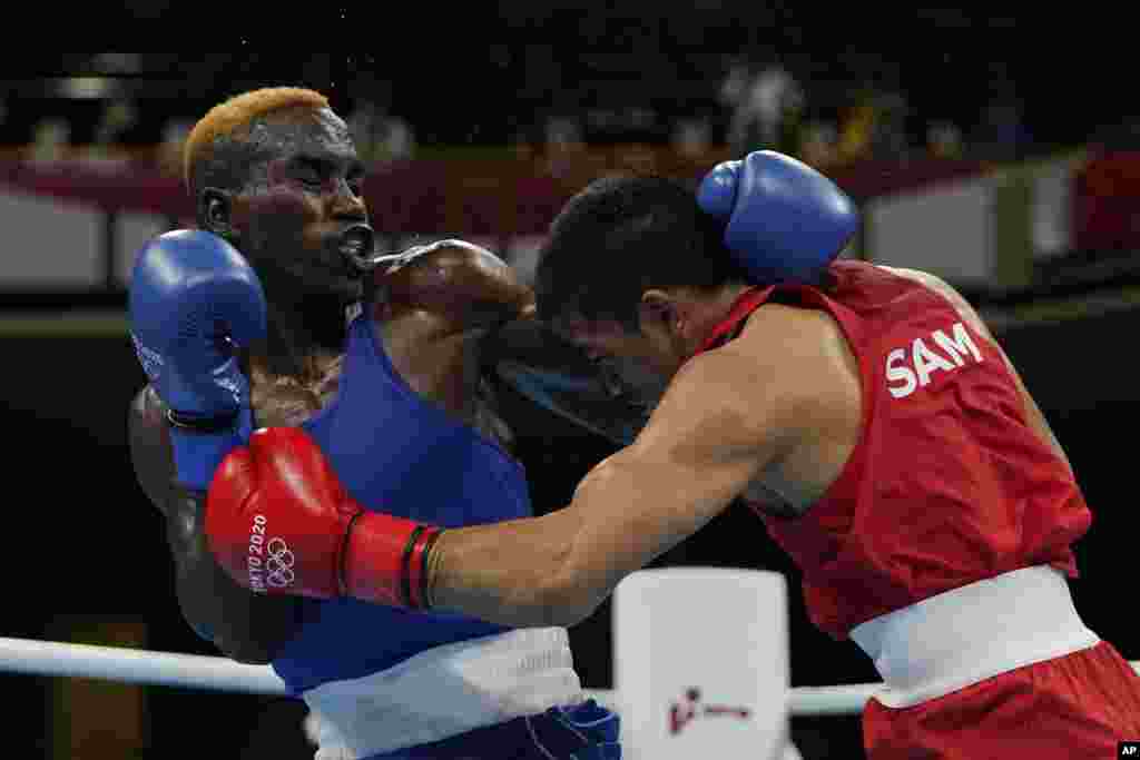 Samoa&#39;s Marion Faustino Ah Tong, right, exchanges punches with Zambia&#39;s Stephen Zimba during their men&#39;s welterweight 69-kg boxing match at the 2020 Summer Olympics, Saturday, July 24, 2021, in Tokyo, Japan. (AP Photo/Frank Franklin II, Pool)