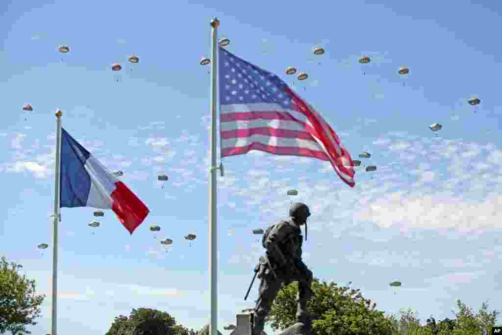 Paratroopers are dropped near the Normandy village of Sainte Mere Eglise, western France, during commemorations of the 70 anniversary of the D-Day landing.