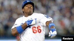 El cubano Yasiel Puig reacciona luego de conectar un triple en la cuarta entrada en el tercer juego de la serie contra los Cardenales de San Luis.