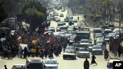 Anti-government protesters march in a street in Cairo, Egypt, Feb 11, 2011