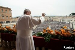 FILE - Pope Francis greets faithful from the balcony overlooking St. Peter's Square at the Vatican, April 21, 2019.