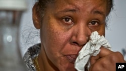 File - Esaw Snipes, the wife of police victim Eric Garner, wipes away tears as she speaks during a panel on police brutality at the 16th National Action Network’s annual national convention opening, April 2015.