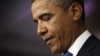 U.S. President Barack Obama looks at his notes during remarks to reporters after meeting with congressional leaders at the White House in Washington, December 28, 2012.