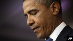 U.S. President Barack Obama looks at his notes during remarks to reporters after meeting with congressional leaders at the White House in Washington, December 28, 2012.