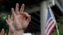 FILE - A demonstrator makes a hand gesture believed to have white supremacist connotations, Aug. 17, 2019, in Portland, Ore. The arrest of a U.S. soldier with far-right sympathies highlights a challenge for the Pentagon: purging its ranks of extremists.