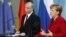 German Chancellor Angela Merkel, right, and President of Russia Vladimir Putin, left, address the media during a press conference after their meeting at the chancellery in Berlin, Germany, June 1, 2012.