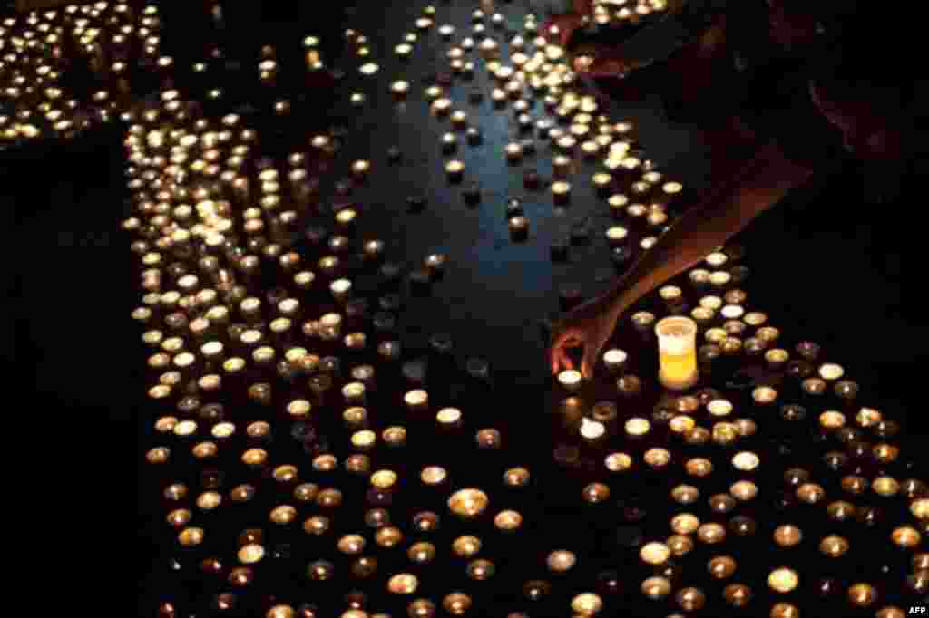 People light candles for the victims of Friday's bomb attack and shooting rampage at the Oslo Cathedral, Norway, Thursday, July 28, 2011. The Norwegian man who admitted killing 76 people in a bombing and youth camp massacre is a sociopath who acted withou