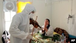 Le Dr Mohamed Salah Siala joue du violon pour les patients des services COVID de l'hôpital Hedi Chaker à Sfax, dans l'est de la Tunisie, le samedi 20 février 2021. 