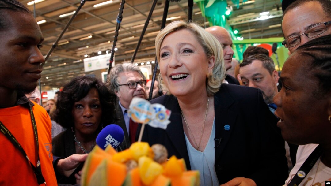 French far-right leader Marine le Pen smiles at the French Caraibean islands stand as she visits the Agriculture Fair Tuesday, Feb. 28, 2017 in Paris. 