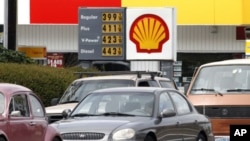 FILE - Gas prices are displayed at a Shell station in Beaverton, Oregon, April 24, 2012. 