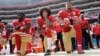 FILE - From left, San Francisco 49ers outside linebacker Eli Harold, quarterback Colin Kaepernick and safety Eric Reid kneel during the national anthem before an NFL football game against the Dallas Cowboys in Santa Clara, California, Oct. 2, 2016.